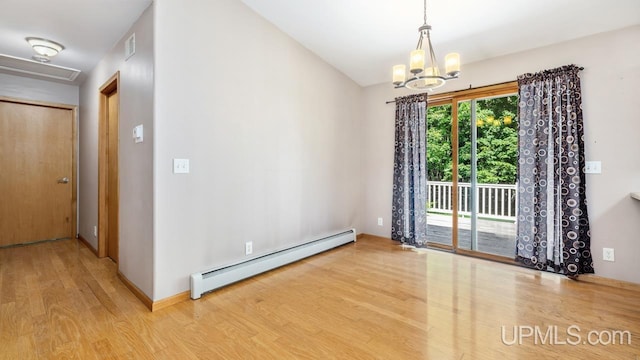 empty room featuring a chandelier, a baseboard heating unit, and light hardwood / wood-style floors