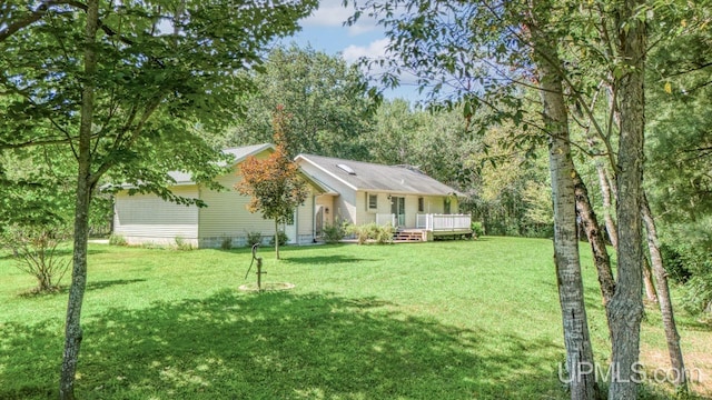 view of front of home with a wooden deck and a front yard