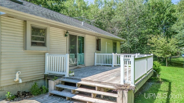 wooden deck featuring a yard