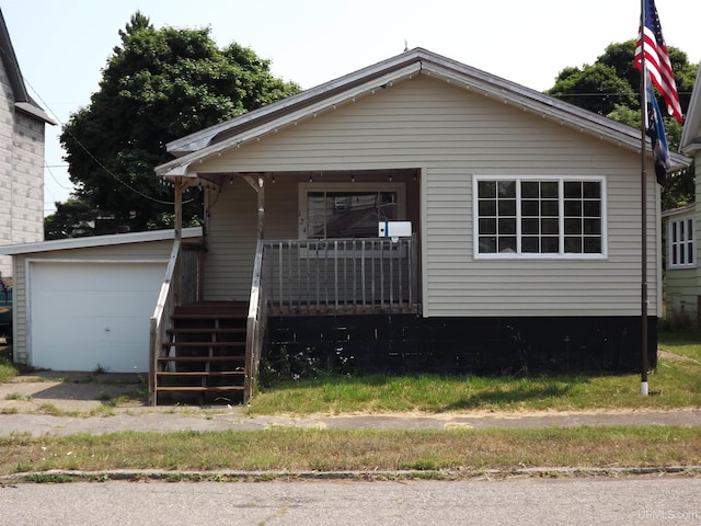 bungalow-style home with a porch and a garage