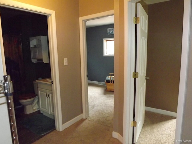 hallway featuring light carpet