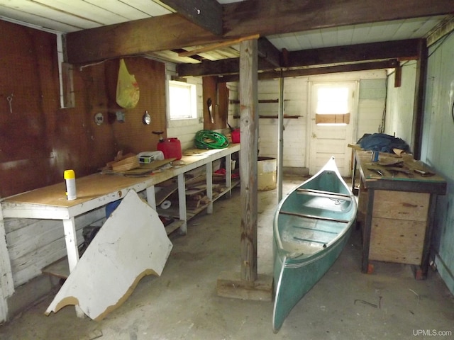 garage featuring a workshop area and wood walls