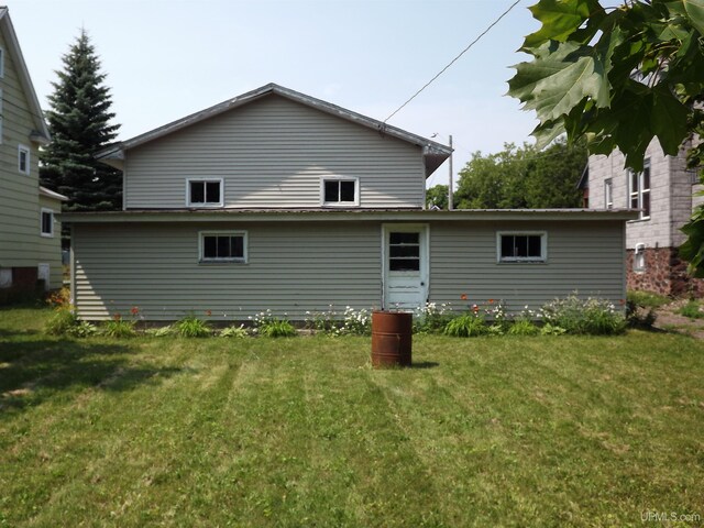 rear view of house with a lawn