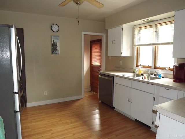 kitchen featuring appliances with stainless steel finishes, light hardwood / wood-style floors, ceiling fan, and white cabinetry