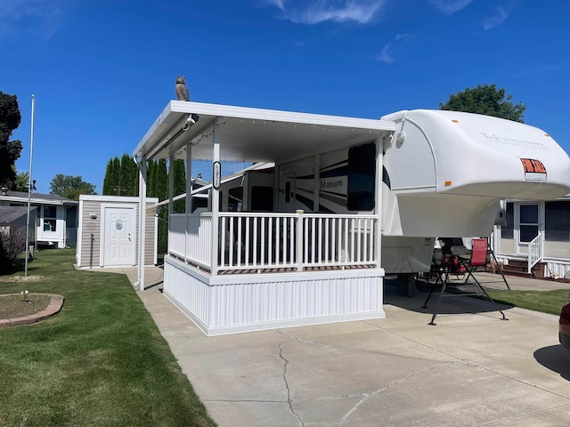 view of property exterior with a lawn and a patio