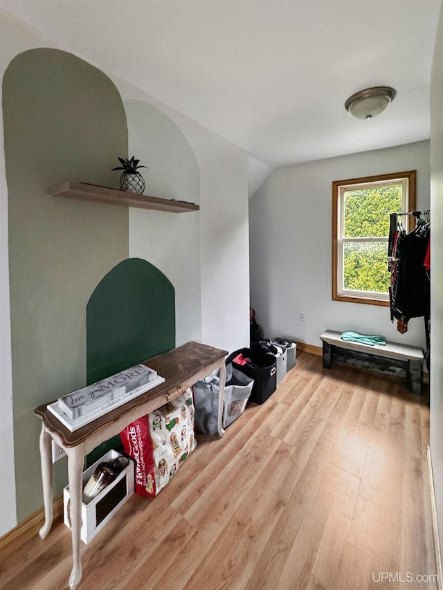 office area with hardwood / wood-style floors and vaulted ceiling