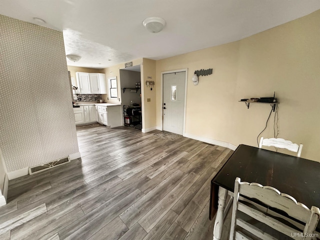 unfurnished living room featuring wood-type flooring