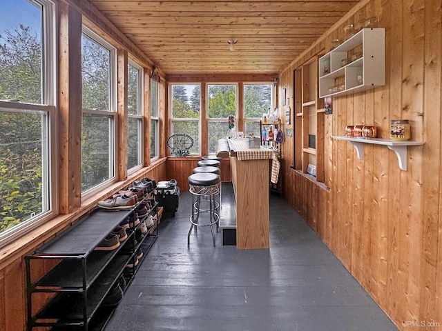 unfurnished sunroom with wood ceiling