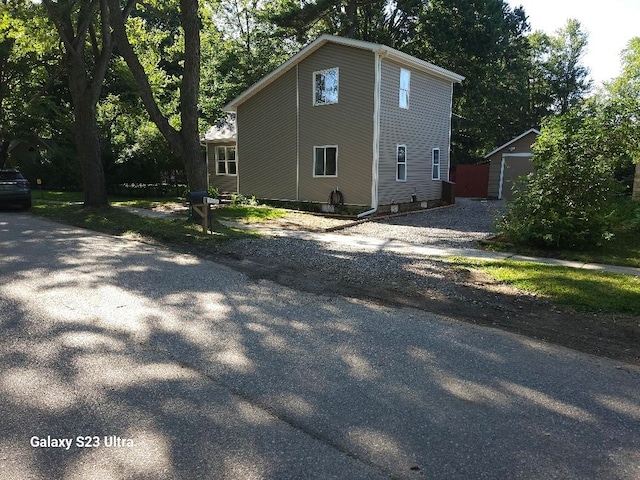 view of home's exterior with an outbuilding and a garage