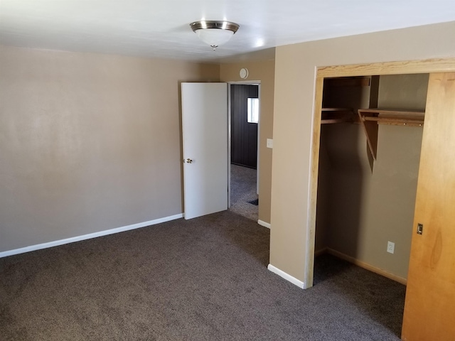 unfurnished bedroom with a closet, baseboards, and carpet floors