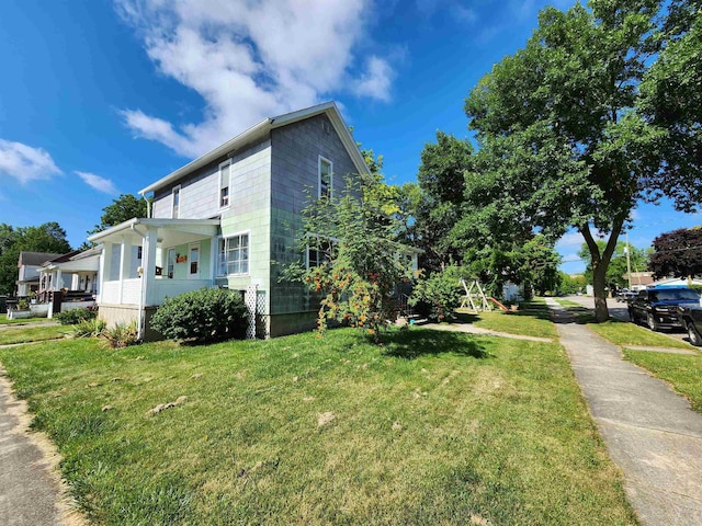 view of property exterior with a lawn