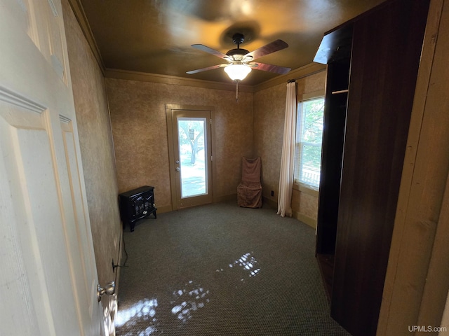 carpeted spare room with ornamental molding and ceiling fan