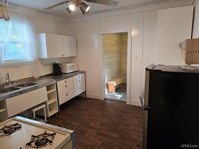 kitchen with ceiling fan, sink, white cabinetry, and dark hardwood / wood-style floors