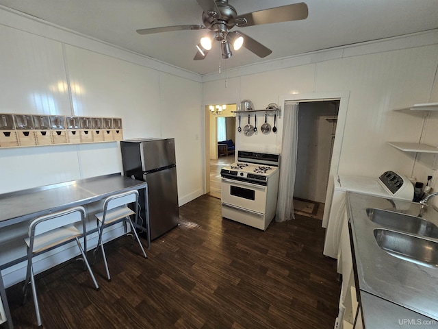 kitchen with ornamental molding, freestanding refrigerator, white range with gas stovetop, and dark wood-style flooring