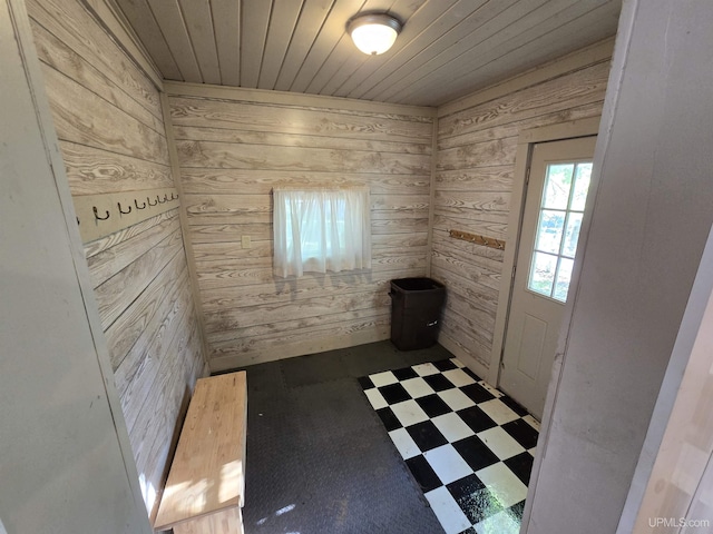 interior space featuring wood ceiling, wooden walls, and tile patterned floors