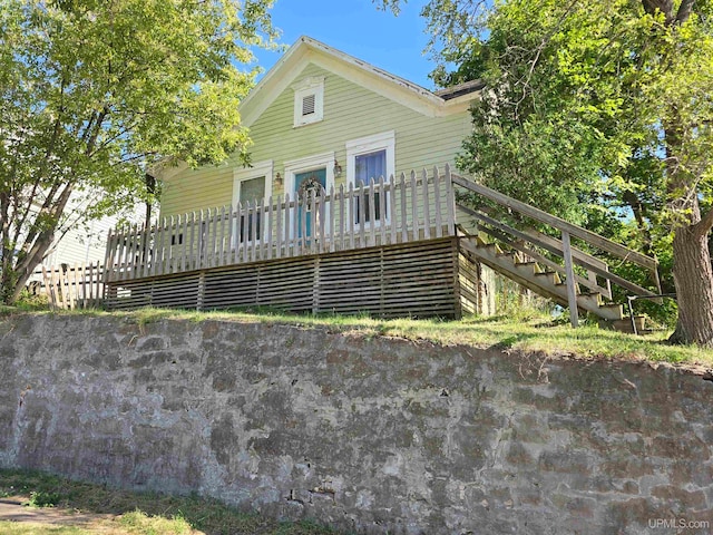 back of property featuring a wooden deck