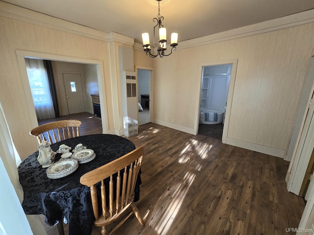 dining area with baseboards, a chandelier, and dark wood finished floors