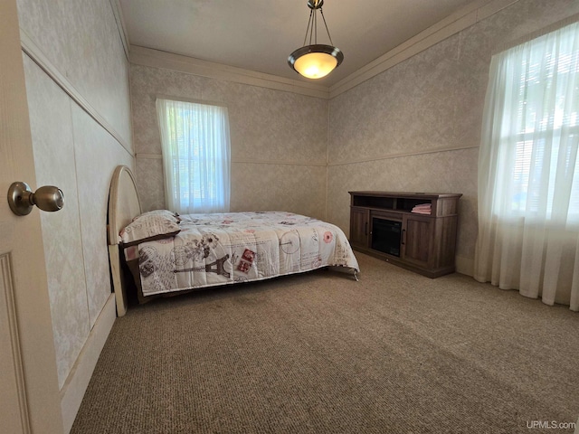 carpeted bedroom with crown molding