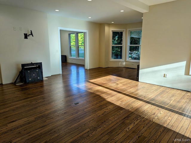 empty room with dark hardwood / wood-style flooring