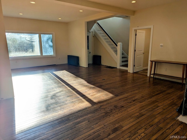 unfurnished living room with dark hardwood / wood-style floors