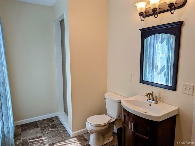 bathroom with vanity, walk in shower, toilet, and tile patterned flooring