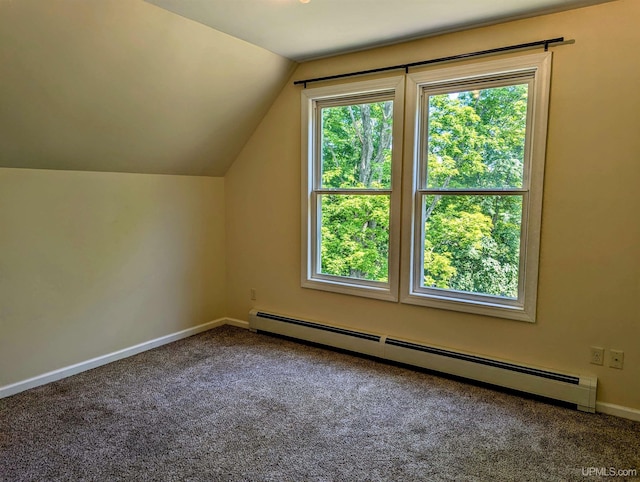 additional living space featuring a baseboard radiator, plenty of natural light, carpet flooring, and lofted ceiling