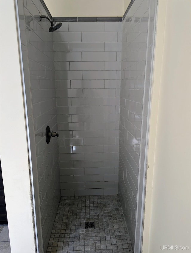 bathroom with tiled shower