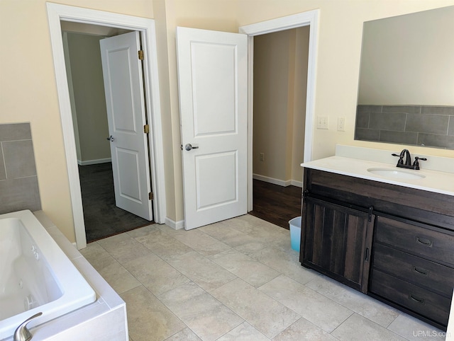 bathroom featuring hardwood / wood-style flooring, vanity, and a washtub