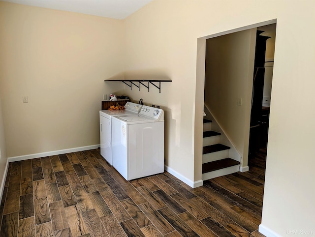 washroom featuring washing machine and dryer and dark wood-type flooring