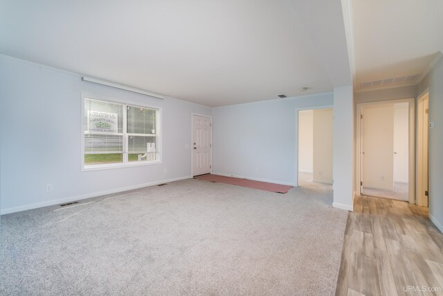 carpeted empty room with ornamental molding