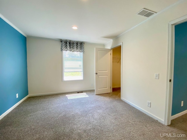 empty room with carpet flooring and ornamental molding