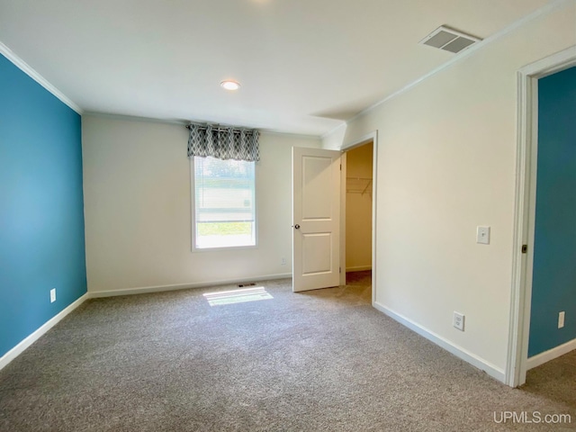 unfurnished bedroom with visible vents, baseboards, and crown molding