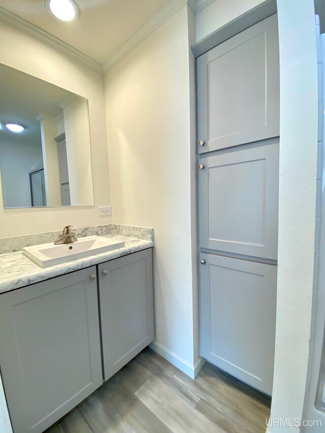 hallway featuring ornamental molding and light hardwood / wood-style flooring