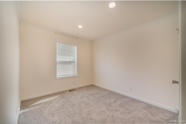 empty room featuring carpet flooring, baseboards, and ornamental molding