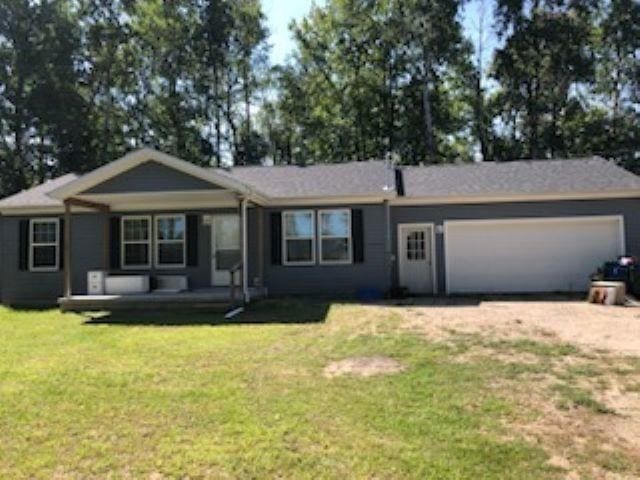 ranch-style house with a front yard, covered porch, driveway, and a garage