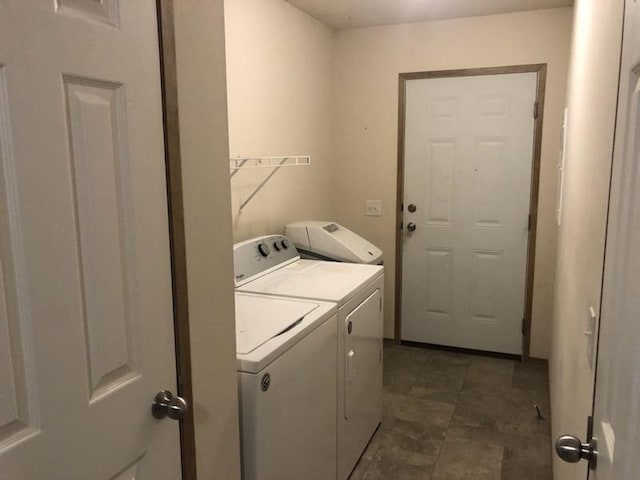 washroom with washing machine and dryer and laundry area