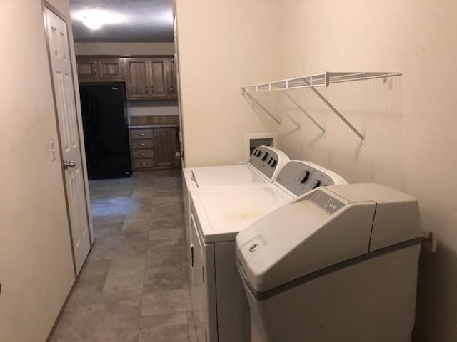 washroom with washing machine and clothes dryer and laundry area