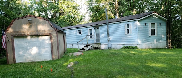 view of front facade with an outdoor structure, a front lawn, and a garage