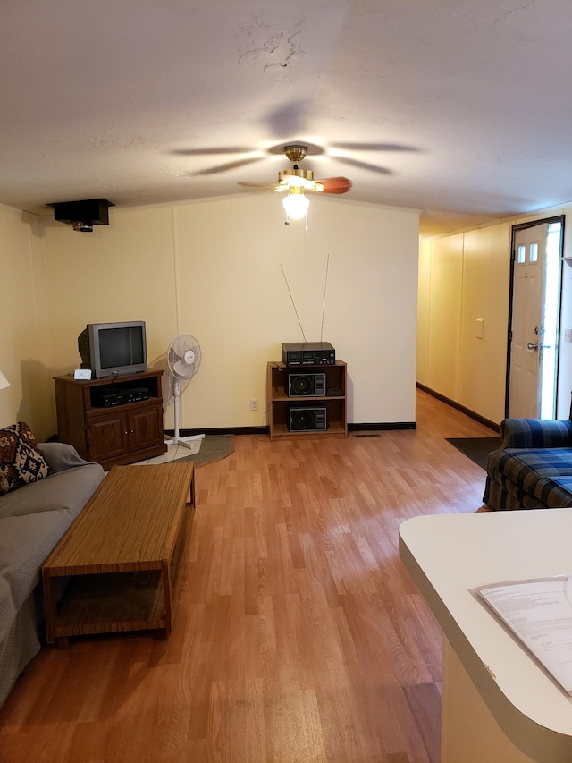 living room featuring ceiling fan and light hardwood / wood-style floors