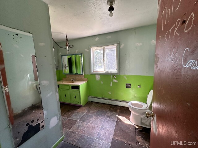 bathroom with a baseboard radiator, toilet, tile patterned floors, and vanity