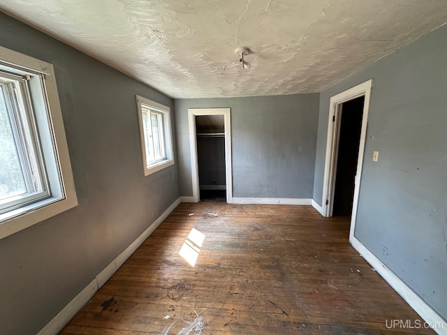 unfurnished bedroom with hardwood / wood-style floors