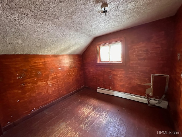 bonus room with a textured ceiling, a baseboard radiator, hardwood / wood-style floors, and lofted ceiling