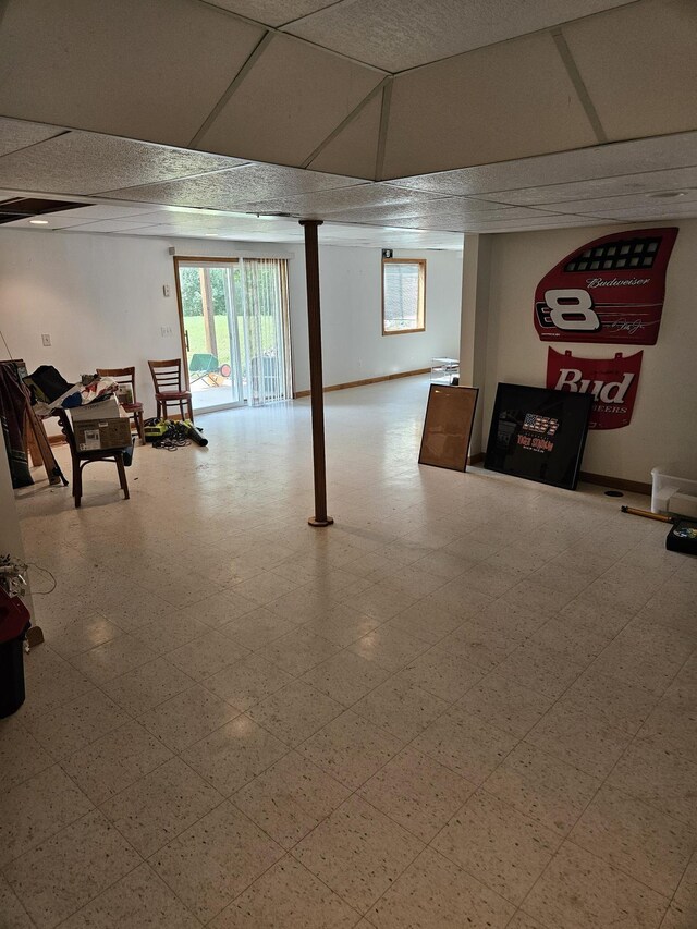 basement featuring a drop ceiling and tile patterned flooring