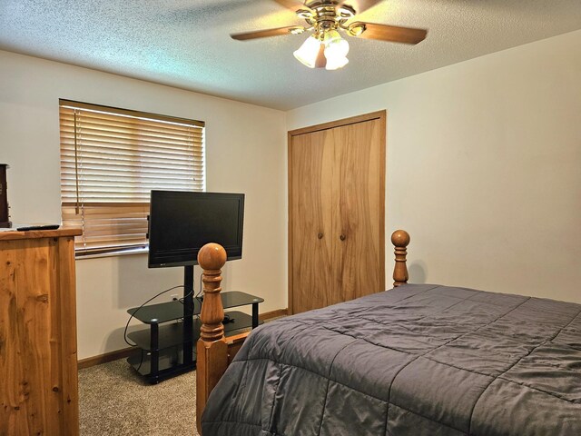 bedroom featuring ceiling fan, a textured ceiling, carpet flooring, and a closet