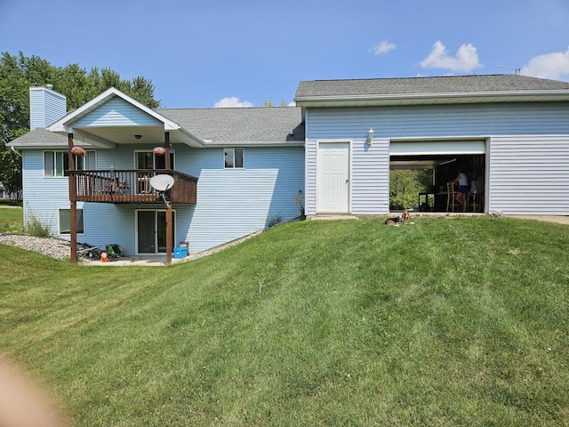 rear view of property featuring a wooden deck and a lawn