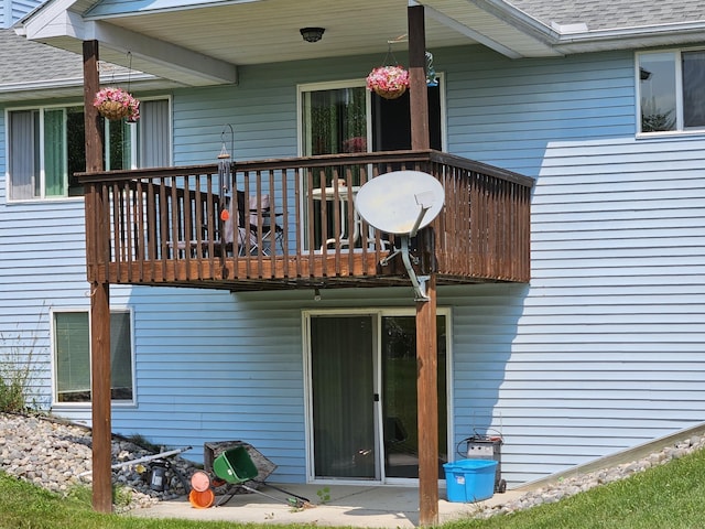 back of property with a balcony