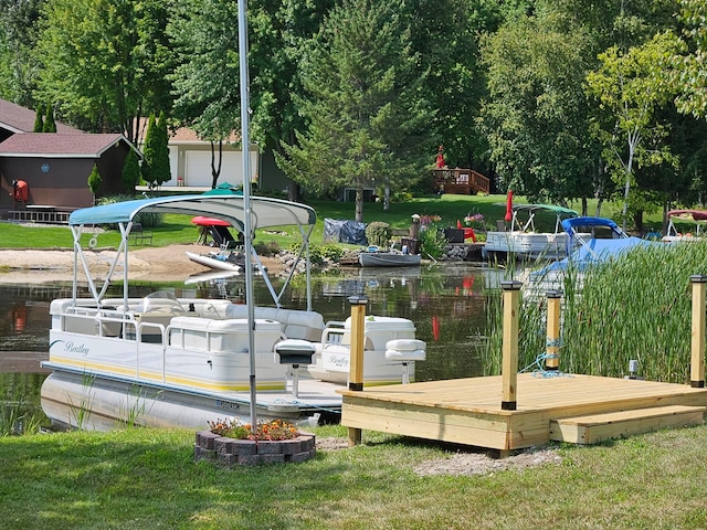 view of dock featuring a lawn