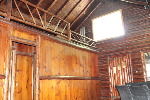 interior space featuring beam ceiling, high vaulted ceiling, and wood ceiling