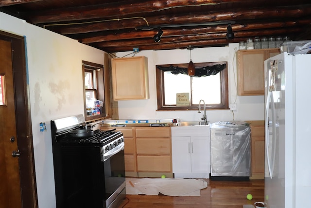 kitchen with beamed ceiling, wood-type flooring, gas stove, and white refrigerator