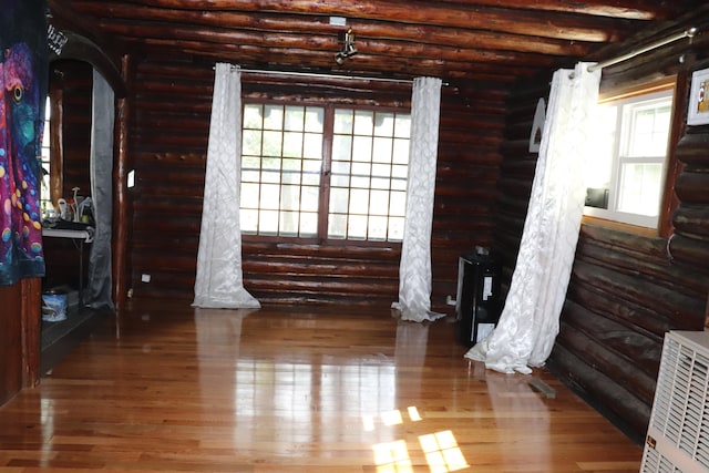 interior space featuring log walls and wood-type flooring